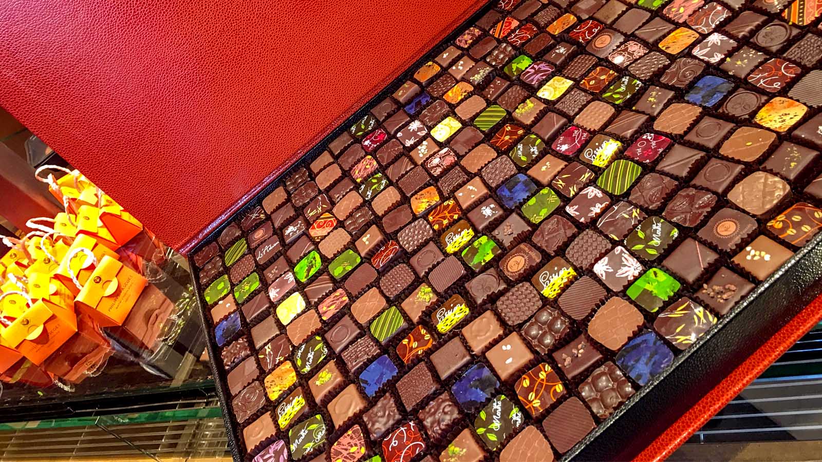  large orange box of colourful pralines during the Geneva chocolate tour organised by Local Flavours Tours